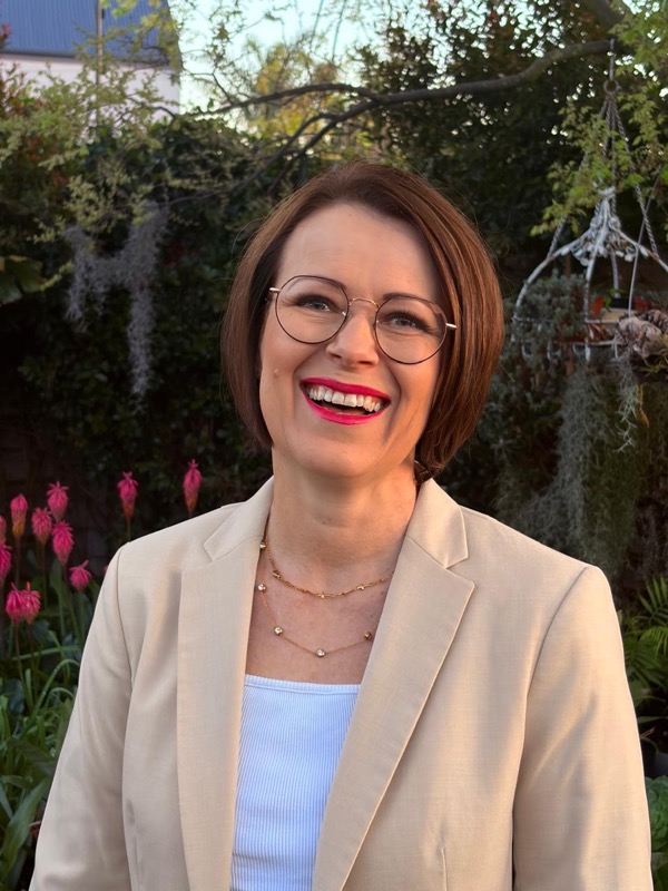 Annerie Beukes smiling in her garden